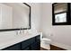 This bathroom offers a modern sink, toilet, framed mirror, and stylish fixtures at 320 Dodd Ln, Alpharetta, GA 30005