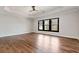 Bright bedroom features hardwood floors, tray ceiling, and natural light from a three-pane window at 320 Dodd Ln, Alpharetta, GA 30005