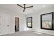 A comfortable bedroom with a ceiling fan, two windows, and a bathroom adjacent to the left at 320 Dodd Ln, Alpharetta, GA 30005