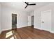 Bright bedroom features hardwood floors, a ceiling fan, and access to an en-suite bathroom at 320 Dodd Ln, Alpharetta, GA 30005