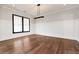 Dining room with hardwood floors, large window, and modern light fixture at 320 Dodd Ln, Alpharetta, GA 30005