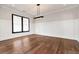 Dining room featuring wainscoting, hardwood floors, a large window, and modern lighting at 320 Dodd Ln, Alpharetta, GA 30005