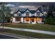 Stunning two-story home with black and white trim, well-manicured lawn, and a welcoming front porch at 320 Dodd Ln, Alpharetta, GA 30005