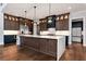 Gourmet kitchen with custom cabinets, large island, stainless steel appliances, and marble countertops at 320 Dodd Ln, Alpharetta, GA 30005