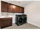 A well-appointed laundry room with modern washer and dryer and plenty of cabinet space at 320 Dodd Ln, Alpharetta, GA 30005