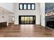 Open-concept living room featuring a fireplace, hardwood floors, and a sliding glass door to the deck at 320 Dodd Ln, Alpharetta, GA 30005