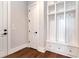 Mudroom area featuring built-in storage with hooks, shelves, cabinets, and drawers at 320 Dodd Ln, Alpharetta, GA 30005