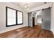 Bright office space featuring a large window, stylish barn door, modern light fixture, and hardwood floors at 320 Dodd Ln, Alpharetta, GA 30005