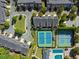 An aerial view shows tennis courts, pool, community green and townhomes in a well-maintained community at 5000 Davenport Pl, Roswell, GA 30075