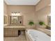 Elegant bathroom with a soaking tub, granite countertop, and neutral color palette at 5000 Davenport Pl, Roswell, GA 30075