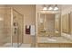 Bathroom featuring granite counters, a glass shower stall, and a beige cabinet at 5000 Davenport Pl, Roswell, GA 30075