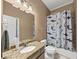 Bathroom featuring granite counters, a beige cabinet, and a shark shower curtain at 5000 Davenport Pl, Roswell, GA 30075