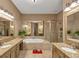 A large bathroom with dual sinks, granite counters, and a stand alone shower at 5000 Davenport Pl, Roswell, GA 30075