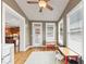 Charming bonus room with natural light, ceiling fan and hardwood floors; connected to kitchen, ideal for playroom or home office at 5000 Davenport Pl, Roswell, GA 30075