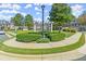 Well-manicured community green space with lush landscaping, pergola and sidewalks in front of townhomes at 5000 Davenport Pl, Roswell, GA 30075