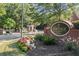 The Heritage at Roswell community sign and entryway with flowers, brickwork, and a guard house at 5000 Davenport Pl, Roswell, GA 30075