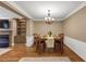 Traditional dining room featuring hardwood floors, chair rail molding, and classic chandelier lighting at 5000 Davenport Pl, Roswell, GA 30075