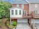 Townhome with a drive-under garage, a second story deck, and a brick facade at 5000 Davenport Pl, Roswell, GA 30075