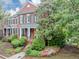 Beautiful two-story brick home with mature trees, lush landscaping, and a welcoming front porch at 5000 Davenport Pl, Roswell, GA 30075