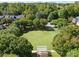 View of large common green space with a white pergola surrounded by mature trees and neighborhood homes at 5000 Davenport Pl, Roswell, GA 30075