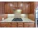 Kitchen granite countertops, gas cooktop, stainless steel appliances, and wood cabinets at 5000 Davenport Pl, Roswell, GA 30075