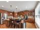 Spacious kitchen boasts wood cabinets, stainless steel appliances, and a granite island with seating for four at 5000 Davenport Pl, Roswell, GA 30075