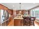 Bright kitchen with wood cabinets, stainless steel refrigerator, granite counters, and a large center island with breakfast bar at 5000 Davenport Pl, Roswell, GA 30075