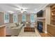 Spacious living room with hardwood floors, fireplace, ceiling fan and ample natural light at 5000 Davenport Pl, Roswell, GA 30075