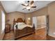 Main bedroom with a ceiling fan, wood floors, and plantation shutters at 5000 Davenport Pl, Roswell, GA 30075