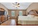 Main bedroom with wood floors, plantation shutters, and a ceiling fan at 5000 Davenport Pl, Roswell, GA 30075
