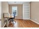 Home office with hardwood floors, built-in bookcase, and natural light ideal for productivity and comfort at 5000 Davenport Pl, Roswell, GA 30075