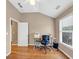 Bright home office featuring hardwood floors, large window, and a vaulted ceiling creating an inspiring workspace at 5000 Davenport Pl, Roswell, GA 30075