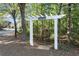A white arbor marks the entrance to the community walking trail near a quiet residential street at 5000 Davenport Pl, Roswell, GA 30075