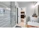 Bright bathroom with a large glass shower, a soaking tub and an open view to the bedroom at 1721 Mcgarity Rd, Temple, GA 30179