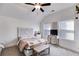 Cozy bedroom with a decorative headboard and sun-filled windows at 1721 Mcgarity Rd, Temple, GA 30179