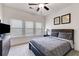 Cozy bedroom with modern furnishings, soft carpet, a ceiling fan, and plenty of natural light at 1721 Mcgarity Rd, Temple, GA 30179
