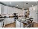 Modern kitchen featuring granite countertops, stainless steel appliances, and a breakfast bar at 1721 Mcgarity Rd, Temple, GA 30179