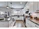 Bright kitchen features granite counters, stainless steel appliances, and modern pendant lighting at 1721 Mcgarity Rd, Temple, GA 30179