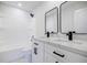 Bright bathroom with white cabinets, marble countertop, double sinks, and black fixtures at 180 Oliver Dr, Locust Grove, GA 30248