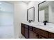 Bathroom featuring double sinks, dark wood cabinets, and tile floors at 180 Oliver Dr, Locust Grove, GA 30248