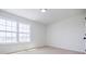 Bright bedroom with two windows and neutral carpet at 180 Oliver Dr, Locust Grove, GA 30248