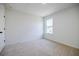 Bright bedroom with neutral carpet and one window at 180 Oliver Dr, Locust Grove, GA 30248