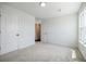 Bright bedroom with neutral carpet and two doors at 180 Oliver Dr, Locust Grove, GA 30248