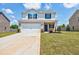 Charming two-story home featuring a two-car garage, brick accents, and a well-manicured lawn at 180 Oliver Dr, Locust Grove, GA 30248