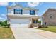 Charming two-story home featuring a two-car garage, brick accents, and a well-manicured lawn at 180 Oliver Dr, Locust Grove, GA 30248