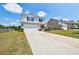 Charming two-story home featuring a two-car garage, brick accents, and a well-manicured lawn at 180 Oliver Dr, Locust Grove, GA 30248