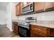 Beautiful kitchen with stainless steel appliances, including a microwave and oven, and dark wood cabinets at 180 Oliver Dr, Locust Grove, GA 30248
