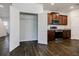 Open closet space adjacent to modern kitchen with stainless appliances and wood cabinets at 180 Oliver Dr, Locust Grove, GA 30248