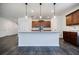 Kitchen island with granite countertop, modern pendant lighting, and stylish dark wood floors at 180 Oliver Dr, Locust Grove, GA 30248