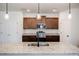 Close-up of kitchen island with granite countertop and pendant lighting, modern sink and faucet at 180 Oliver Dr, Locust Grove, GA 30248